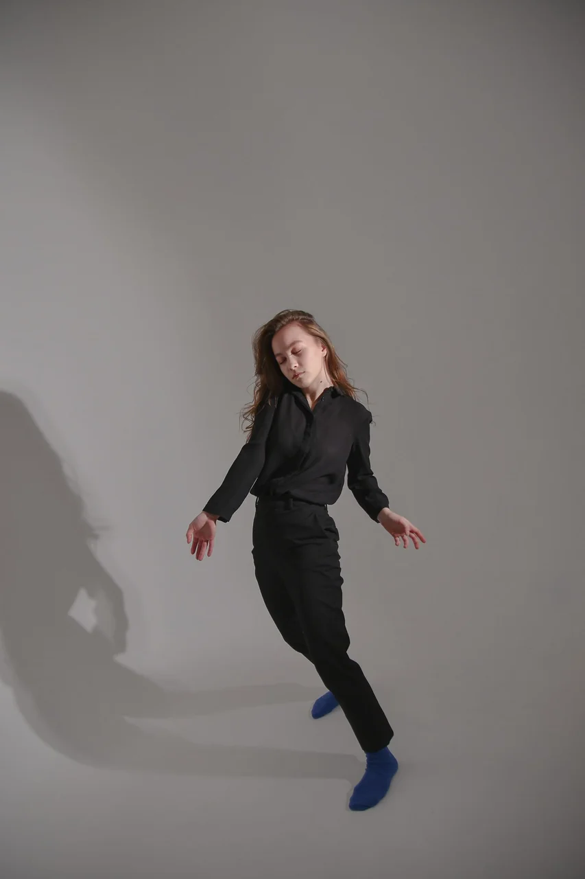 Dancer in graceful silhouette expressing stillness and poise in the dance studio