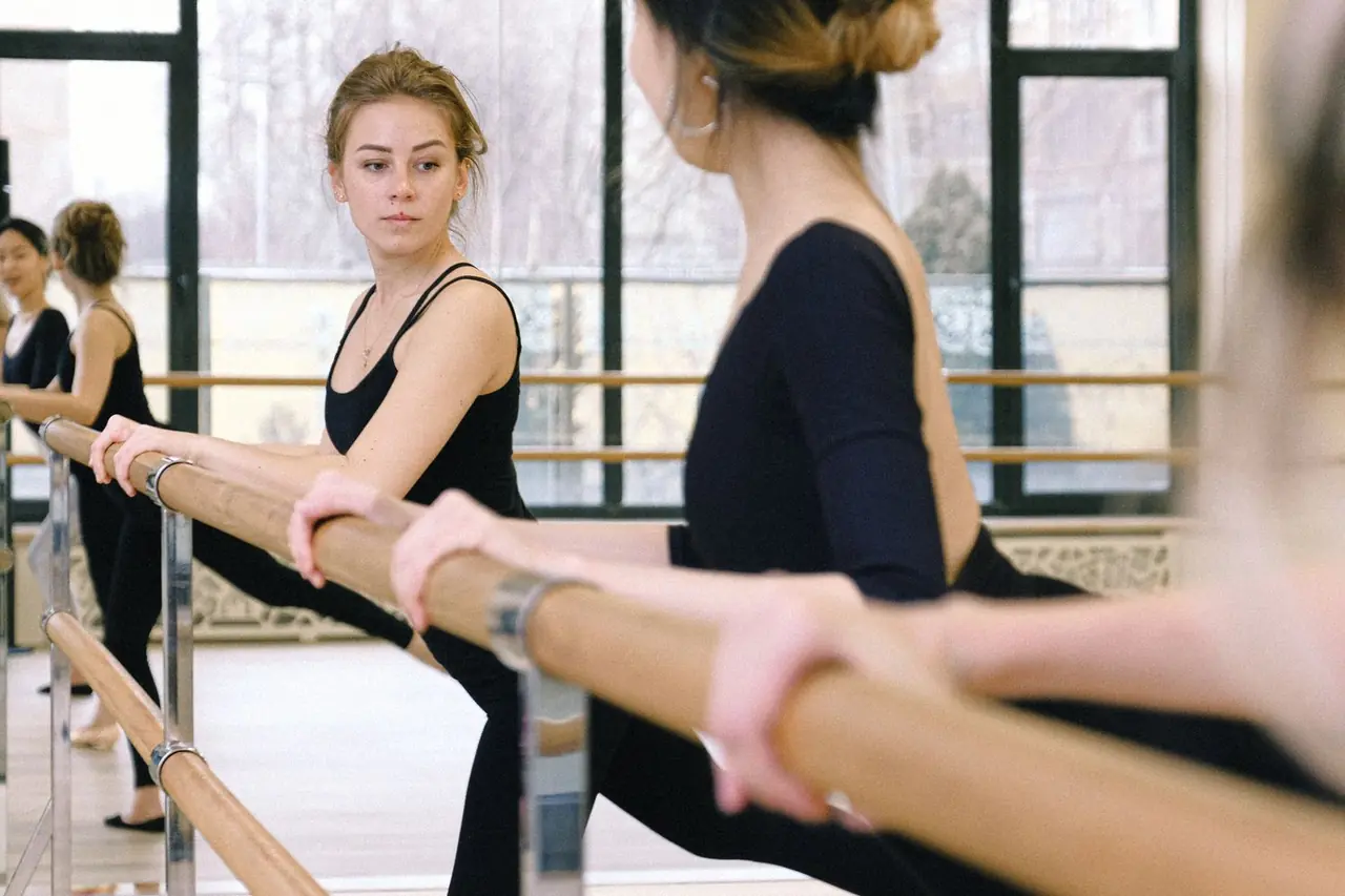 Ballet students gathered at the barre during a disciplined morning warm-up