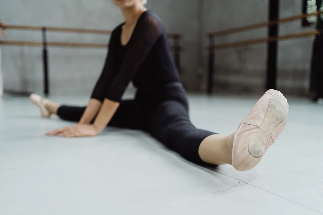 Artistic close-up of pointe shoe alignment and focused floor stretch