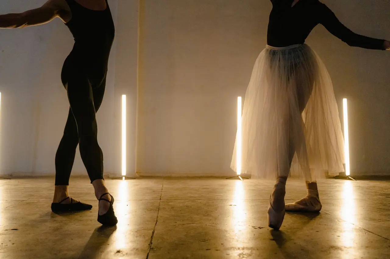 Two dancers in disciplined rehearsal dialogue