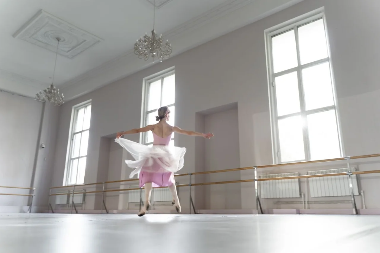 Floor-to-ceiling mirror panels offering clear posture reflection in the dance studio